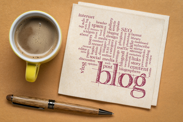 Blog notes on napkin with coffee and pen