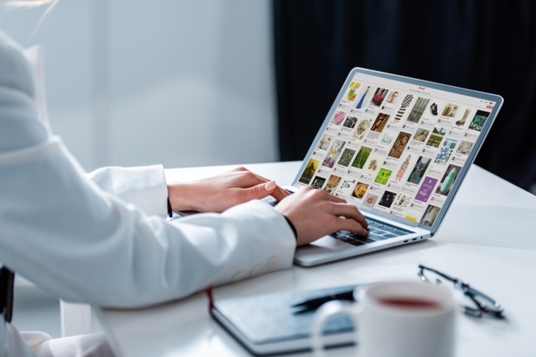 Pinterest on laptop screen with hands