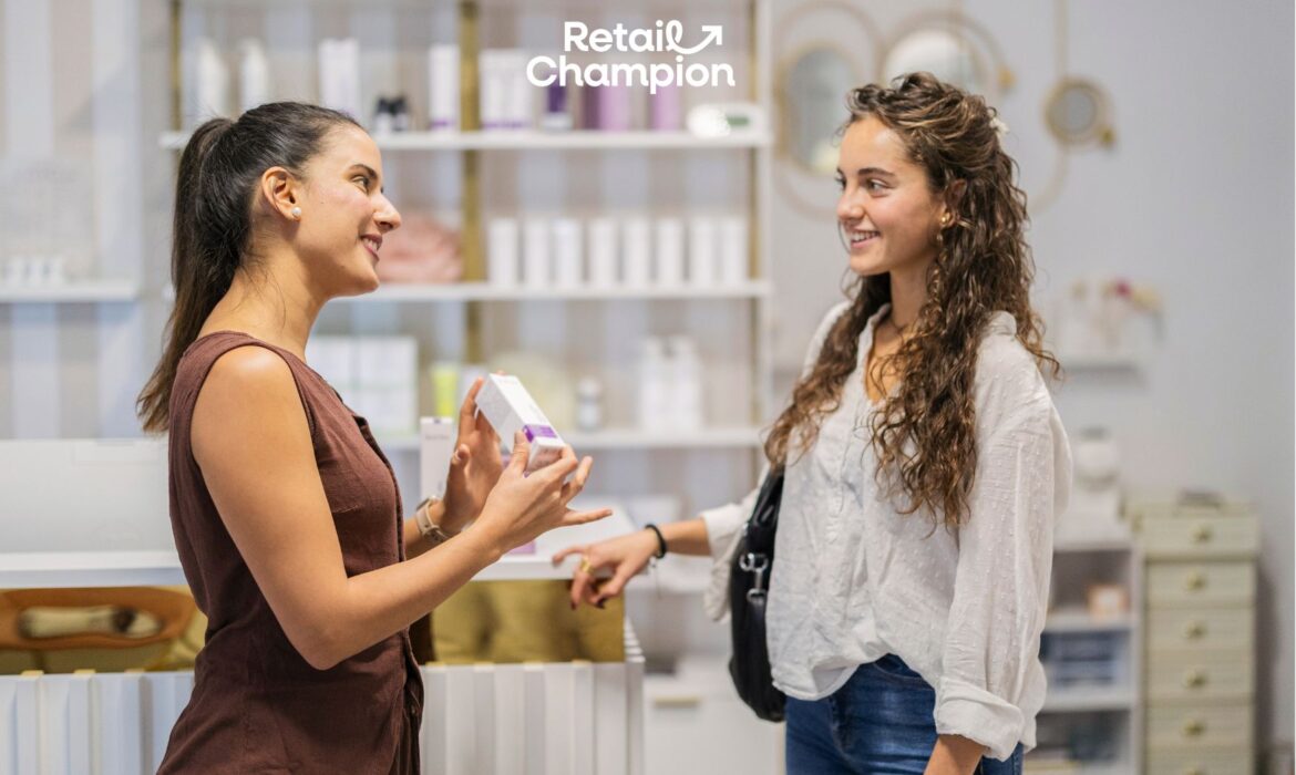 Two women in a shop talking, one holding a small bo