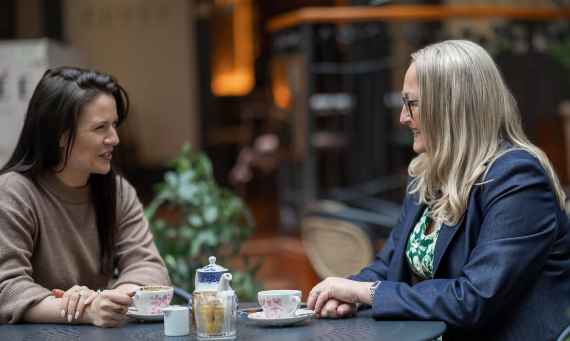 Two women talking over coffee