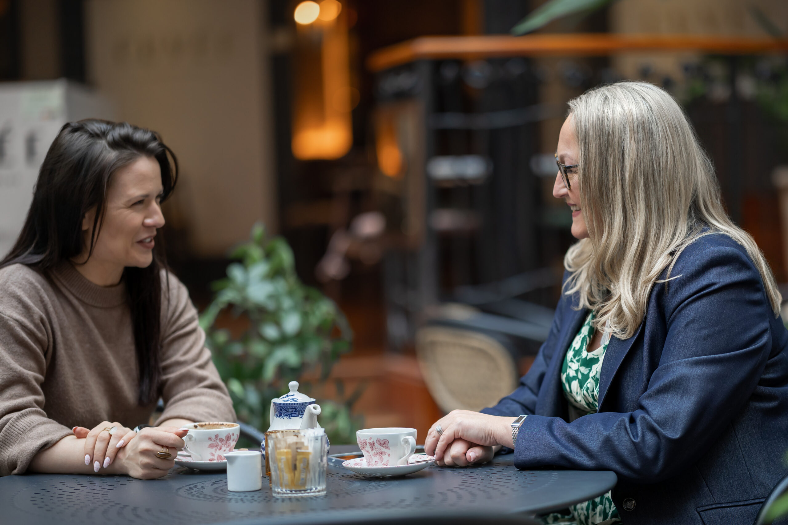 Two women talking over coffee