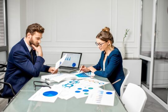 A business team reviewing customer insights to inform commercial decisions.