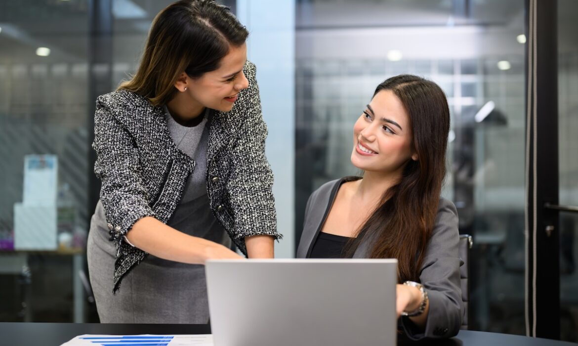Colleagues reviewing a shared business report before making a decision.